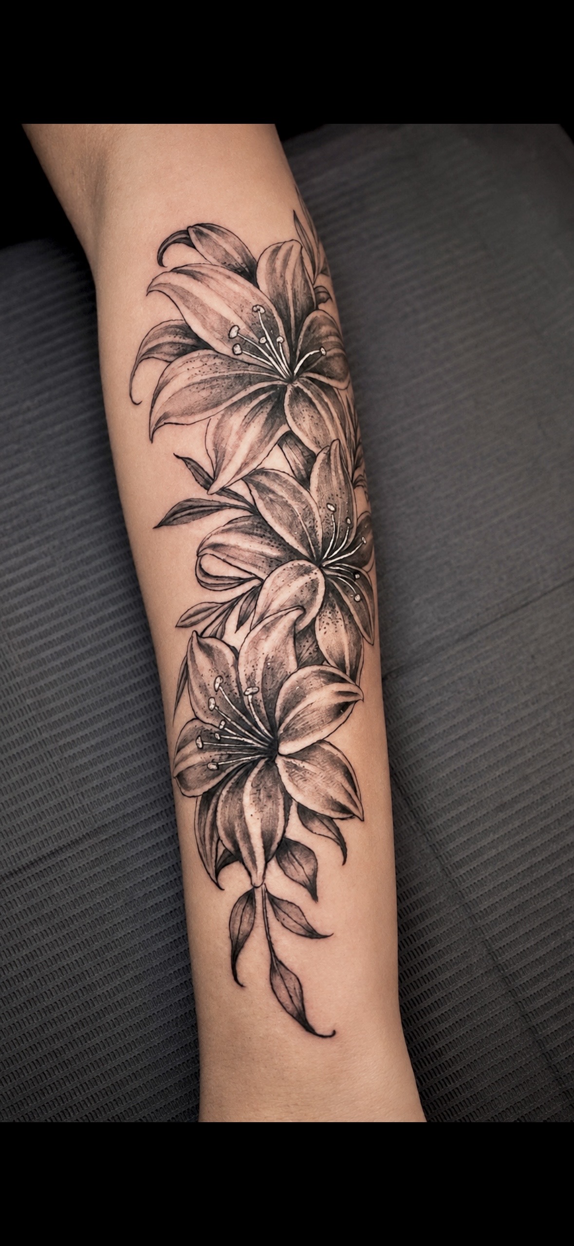 Lilies tattoo by John Paul Curtis